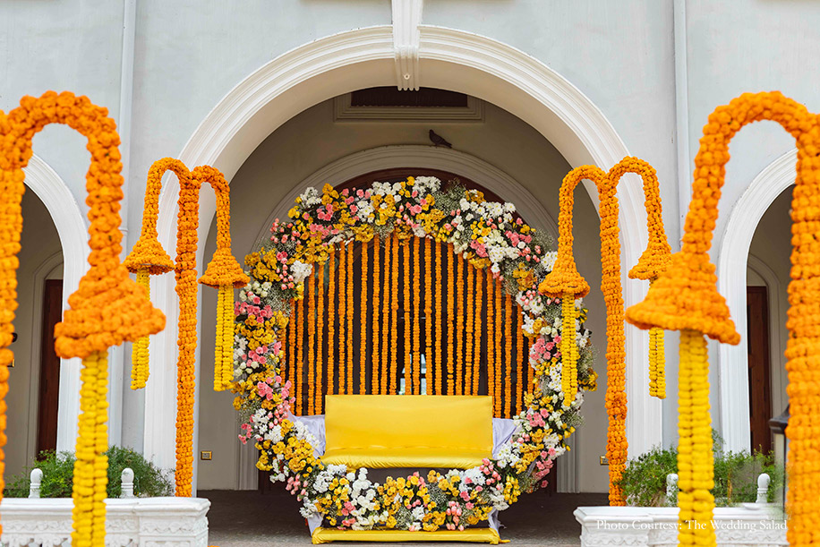 Haldi and Chooda decor with with colorful flowers and marigold at Taj Falaknuma Palace, Hederabad