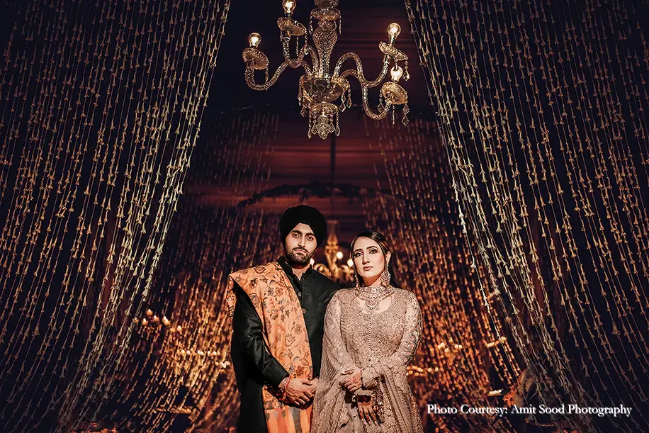 Bride wearing beige outfit and groom wearing black Sherwani for the Sufi Night