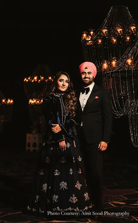 Bride wearing blue dress for the cocktail and groom wearing black tuxedo for the cocktail