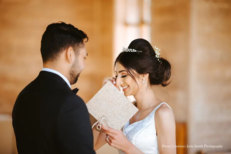 Bride in white gown and groom in black tuxedo for the white wedding