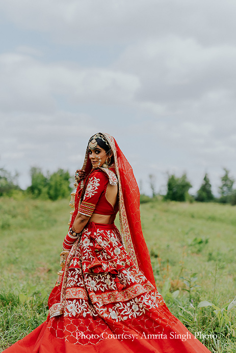 Red bridal lehenga with statement polki jewelry and traditional red and gold chooda