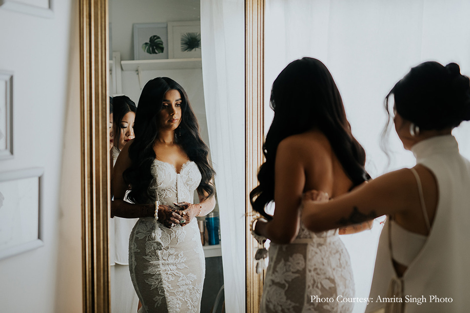 Bride in a show-stopping mermaid-cut white lace gown with a nude underlay