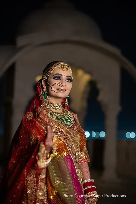 Bride in a rich gilded lehenga by Rimple and Harpreet Narula for her wedding