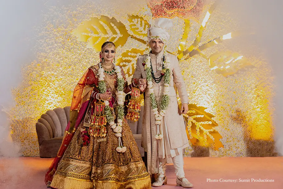 Bride in a rich gilded lehenga by Rimple and Harpreet Narula and Groom wearing blush pink sherwani by Tarun Tahiliani for the wedding
