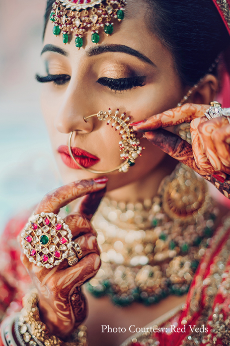 Bride in red lehenga with elaborate polki jewelry