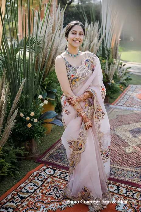 Bride wearing beige saree with coloful embroidery by Anamika khanna for lunch party
