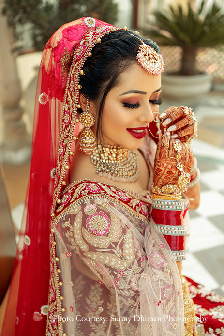 Bride wearing Red lehenga by Mongas and Kundan jewelry for Wedding