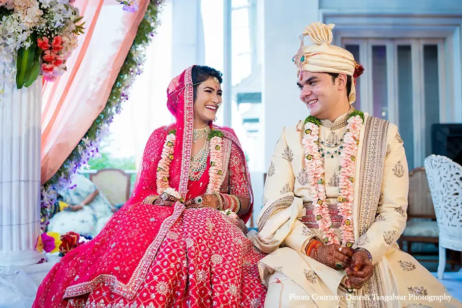 Bride wearing pink lehenga by Anita dongre and groom wearing cream sherwani for the wedding at Taj Falaknuma palace, Hyderabad