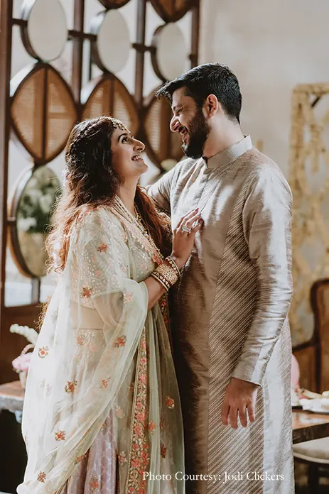 Bride wearing pista green lehenga with o=peach embroidery and rani haar and groom wearing ivory sherwani by manish malhotra for the civil wedding