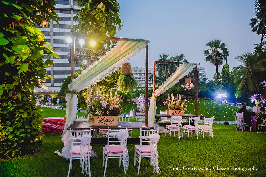 Mehndi decor with a profusion of pretty spring blooms, vintage white furniture, a swing and props