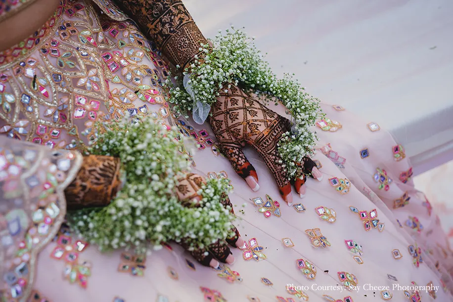 Bride wearing baby's-breath in hands for the Mehndi