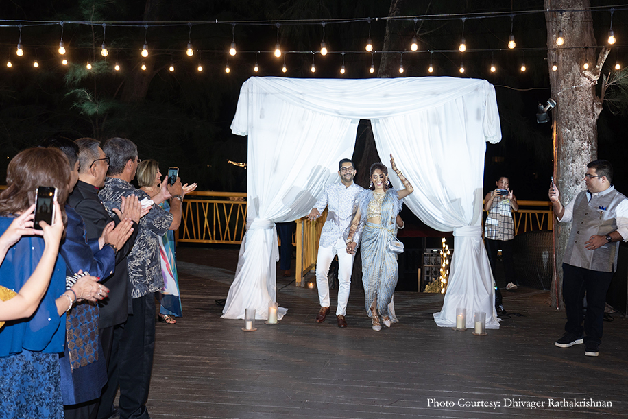 Couple in shimmering silver outfits for welcome dinnder at thailand