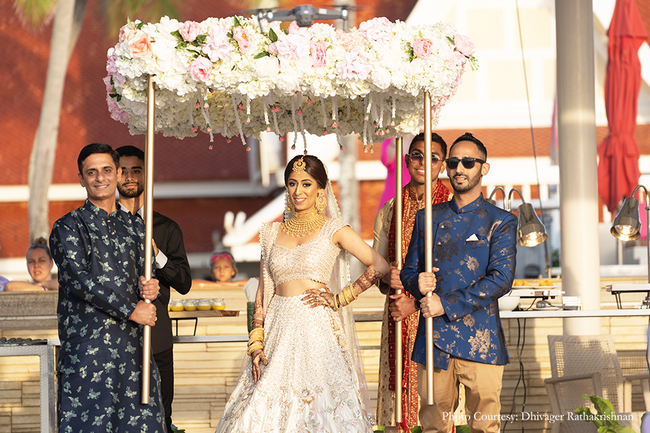 bridal entry in Blush lehenga with golden jewelry