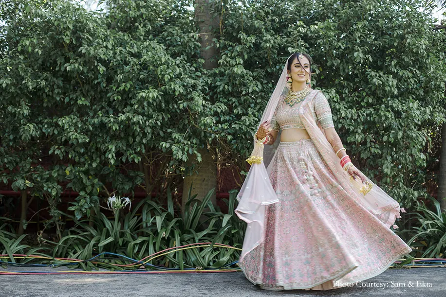 Bride wearing blush lehenga for the wedding
