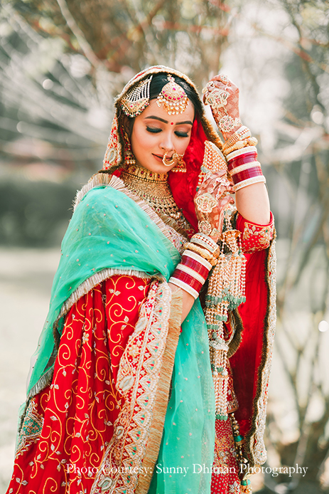 Bride wearing Rajasthani embroidery red and turquoise lehenga at Ludhiana