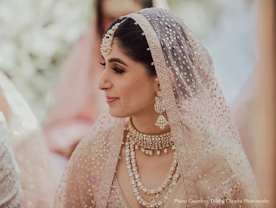 Bride in a Tarun Tahiliani ensemble with delicate floral motifs and appliqué-work