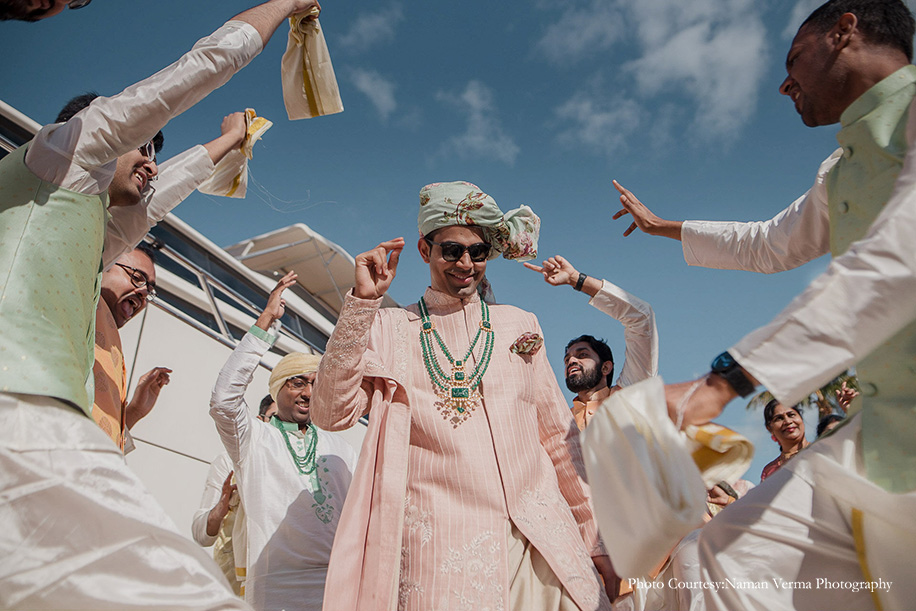 Groom entry on a yacht in pink sherwani