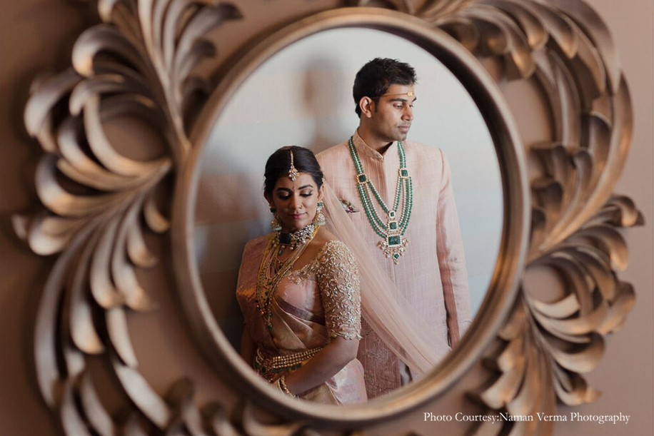 Bride in mauve silk saree with Kundan jewelry and Groom wearing pink sherwani