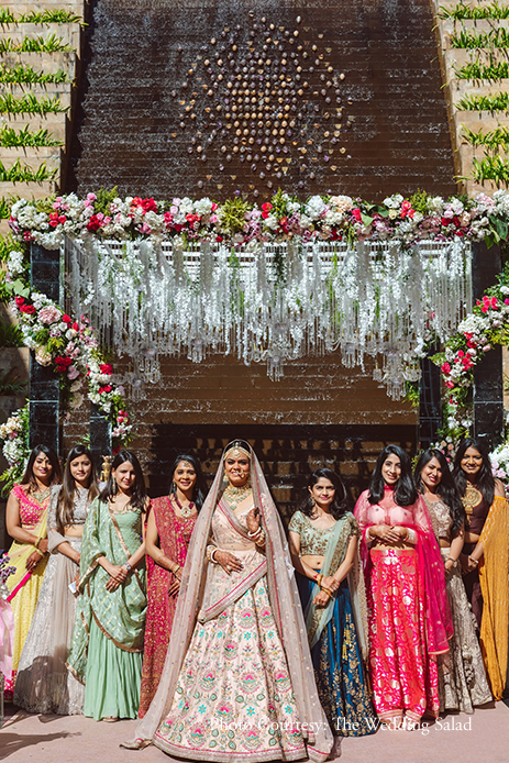 Bride in pink floral lehenga by Sabyasachi Mukherjee with Bridesmaids