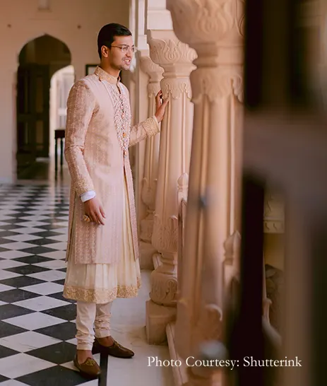 Groom in embroidered and heavily accessorized royal sherwani