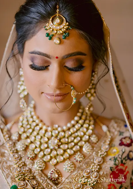 Bride in multicolored lehenga and Kundan jewelry