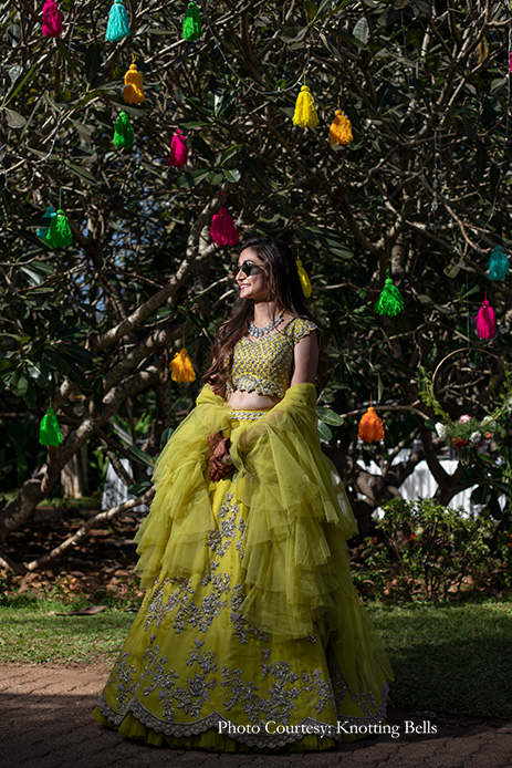 Bride wearing lemon hued, embellished lehenga by Anushree Reddy for mehndi
