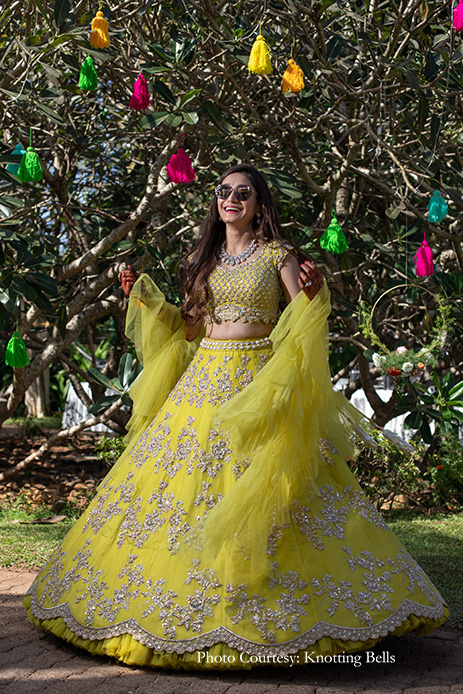 Bride wearing lemon hued, embellished lehenga by Anushree Reddy for mehndi