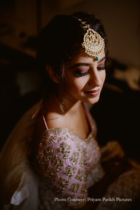 Bride wearing silver and blue lehenga for the sangeet