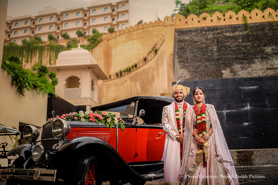 Bride wearing Blush pink lehenga and Groom in Ivory and pink sherwani for the wedding