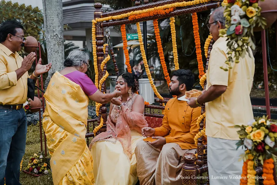Haldi ceremony antique swing decorated with vivid marigolds