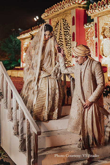 Bride wearing beige lehenga by Esha Sethi Thirani and groom wearing beige sherwani by Sood for Nikah