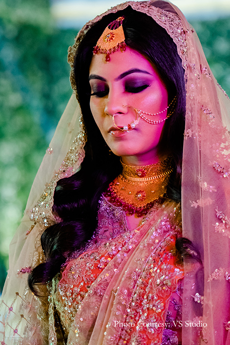 Bride wearing beige and orange outfit by Esha Sethi Thirani for reception