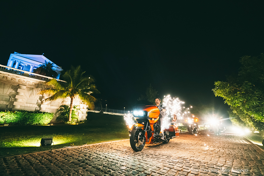 Groom entry on a motorcycle with fireworks at Taj Falaknuma Palace