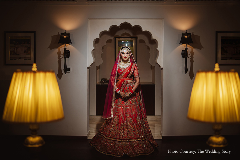 Bride wearing red lehenga by Tarun Tahiliani at Wedding