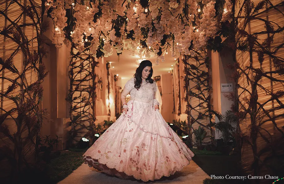 Bride wearing peach lehenga for the sangeet