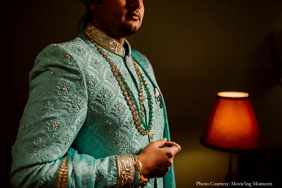 groom wearing mint green sherwani with kundan jewelry and safa for the wedding