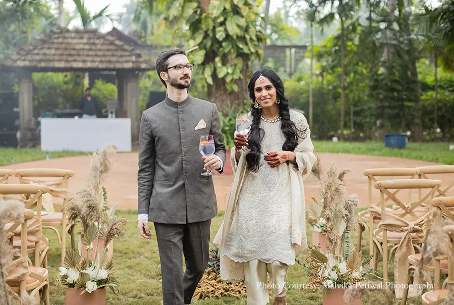 Bride wearing off-white dress and groom wearing Bandh-gala for the engagement ceremony