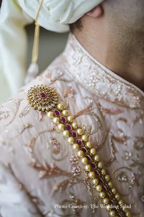 Groom in ivory sherwani with intricate embroidery in blush pink