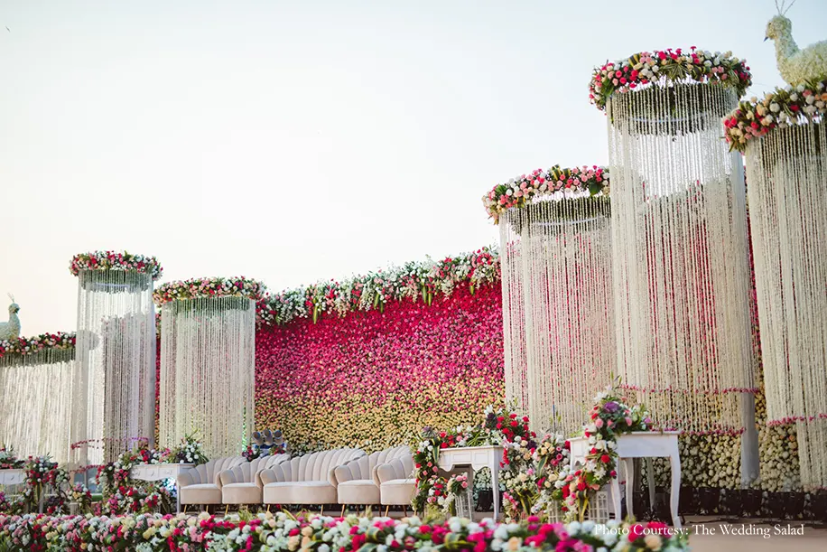 A gigantic ombre wall of pink blooms and towering circular columns of white flowers